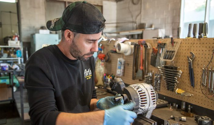 Art's Auto Electric technician repairing an alternator
